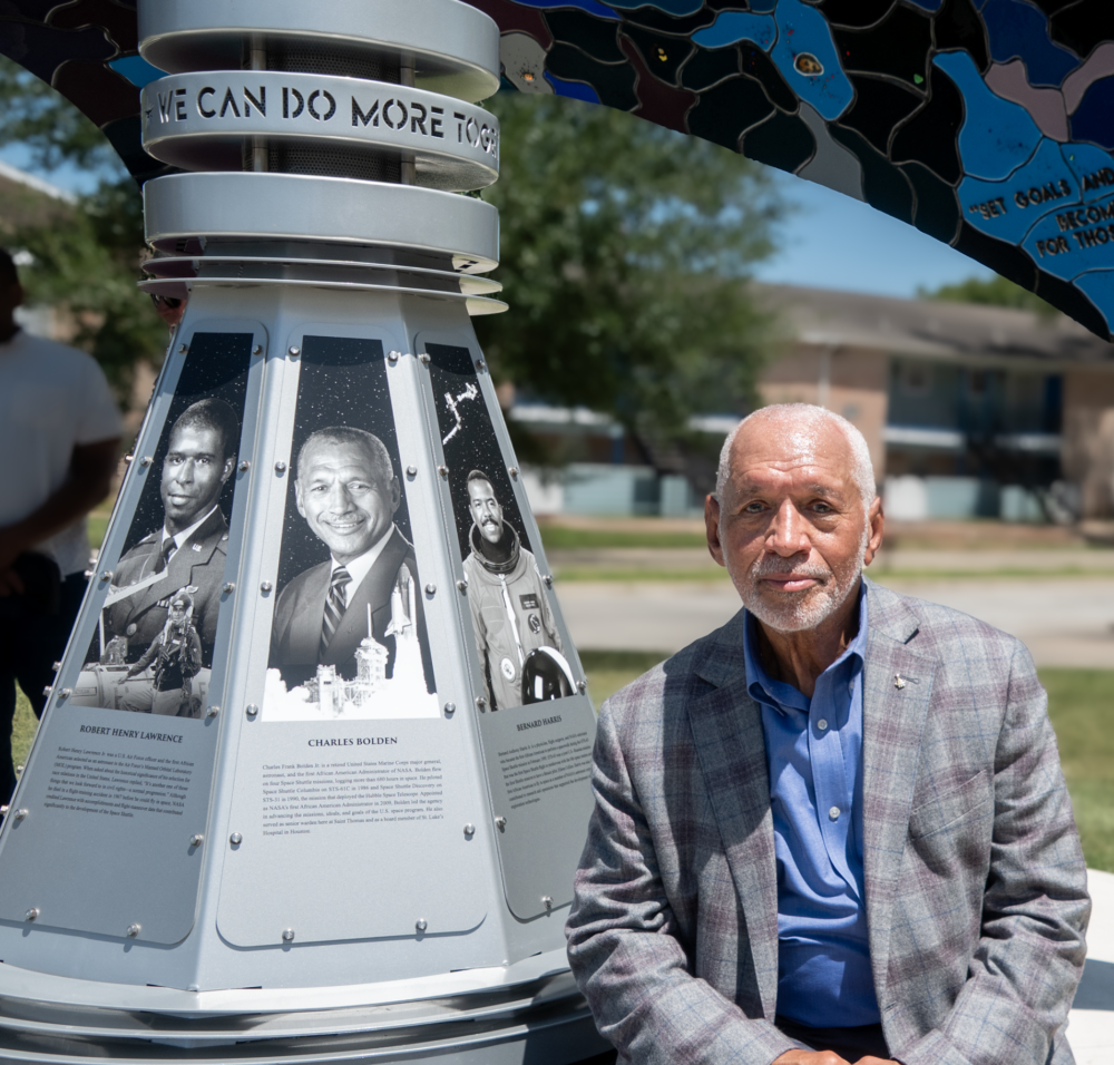 Charles Bolden poses next to the EarthRise monument